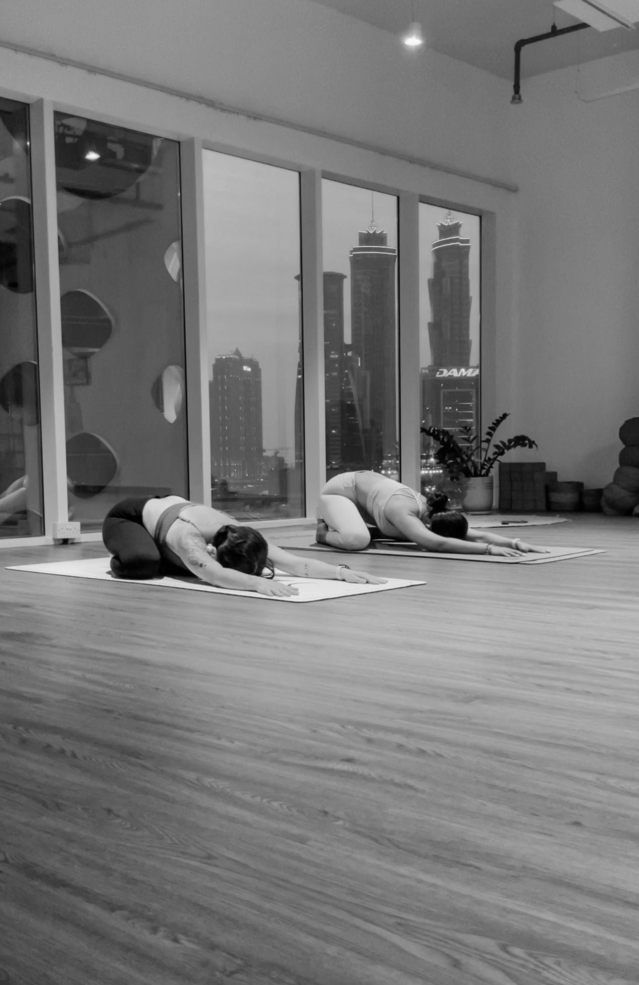 Karina and her best friend in child's pose, mat to mat